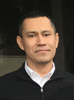 David Jara a hispanic man with dark hair wearing a zip up black cardigan over a white collared shirt